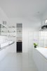 Modern home with Bath Room, Open Shower, Ceiling Lighting, Recessed Lighting, and Vessel Sink. The bathroom’s glass block partition is just one example of the extensive list of repurposed materials used for this project. The sinks are from IKEA and bathtub is from Home Depot. Photo 7 of Hillside House No. 3