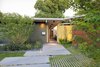 Modern home with Exterior, House Building Type, Shed RoofLine, and Mid-Century Building Type. An ipe fence and a neon-yellow resin screen fashioned from recycled acrylic panels draw visitors toward the entrance to the Kreadens’ renovated Eichler house. Photo of Modern Master: Joseph Eichler