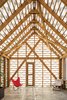 Because of its semi-opaque envelope, the building takes on a life of its own: It glows in the evenings and its framing casts shadows that dance throughout the interior during the day. Photo of Inexpensive Gabled Garden Shed in Belgium modern home