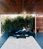 Modern home with Outdoor and Back Yard. Sebastian and Maricarmen take in the scenery from the comfort of their exposed living room. The couple sits on a Polder sofa by Hella Jongerius for Vitra. Photo of Design Guide: San Diego