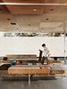 Modern home with Living Room, Sofa, and Concrete Floor. Matthew sets about finishing his latest knitting project while lounging on furniture of his dad’s design. A sound system and lighting by Halo are recessed into the ceiling. Photo of Design Guide: San Diego