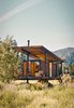 Modern home with Exterior, Cabin Building Type, Butterfly RoofLine, Metal Siding Material, Metal Roof Material, and Glass Siding Material. The steel-clad Rolling Huts designed by Olson Kundig Architects in Manzama, Washington, sit lightly on the land thanks to wheels that allow the tiny residences to "hover" above the site, optimizing views of the landscape. Photo by Derek Pirozzi. Photo of Simple American Getaways