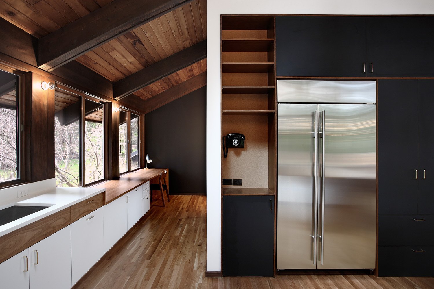 The kitchen was originally an awkward alcove facing the main living area. The architects expanded the room and installed a classic modernist ‘service core’ at the kitchen’s center; it features large appliances such as a Sub-Zero fridge and an Asko washer/dryer. This allows easy movement through the kitchen to the adjacent dining room and main hallways.