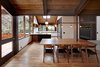 The light fixtures, a string of dangling lights seen above the dining table, emulate what SHED Architects principal Thomas Schaer calls Zema’s “builderly” style: straightforward and unpretentious. The wooden screens, seen top right, are all-new to the house but follow Zema’s Japanese-inspired style. Photo 4 of Zema Redux modern home