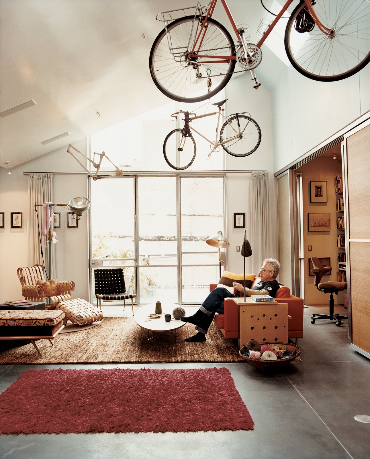 The living room is a comfortable melange of pieces Baker grew up with, such as the Robsjohn-Gibbings chaise, and ones he's added, such as the Frank Gehry Power Play club chair.