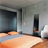 Modern home with Bedroom, Bed, Medium Hardwood Floor, and Chair. The master bedroom is spartan. Photo of Our Favorite Bedrooms