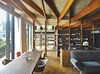 Modern home with Living Room, Medium Hardwood Floor, Table, Chair, Shelves, and Sofa. In the open living and dining room of a hillside family home in Japan, Eames shell chairs surround a custom walnut table by Kagura. The upholstered seating is by Arflex. The architect, Masahiro Harada of Mount Fuji Architects Studio, also designed the custom kitchen island and stove vent. Photo of Eames Molded Chairs