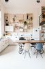 Modern home with Kitchen, Refrigerator, White Cabinet, Open Cabinet, and Ceiling Lighting. The kitchen is completely open to the main living area and features a custom birch pegboard wall. Eames dining chairs accent the space. Photo 4 of The Schoolhouse
