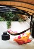 Modern home with Outdoor. At one end of the space, which is topped by a barrel ceiling, a hammock offers a tantalizingly cozy place to nap. Photo of How to Design with Orange