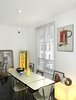 Modern home with Dining Room, Table, and Chair. A simple poster with bold colors adds to the industrial character of this Paris abode. Photo by Céline Clanet. Photo of How To: Decorating with Posters