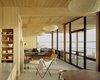 Modern home with Living Room. Inside, the kitchen, dining and living areas are separated by breezeway from the master suite and the children’s bedrooms. “It’s small,” Cary said. “I wanted to design it, but not architect it.” Courtesy Architects and Artisans. Photo 7 of Shelter Island Retreat