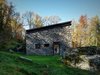 Modern home with Exterior, Stone Siding Material, Cabin Building Type, House Building Type, and Shed RoofLine. Reinforced concrete stands behind the stone facade to provide insulation. Vanotti wanted to focus this project on the simple materials of concrete, natural larch, iron, and wood. Photo of A Stunning Alpine Home with Sweeping Views and Custom Crafted Interior