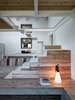 Modern home with Staircase and Metal Tread. The stairs are made of iron, which was coated with white paint from San Marco. Photo of A Stunning Alpine Home with Sweeping Views and Custom Crafted Interior