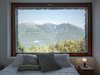 Modern home with Windows and Picture Window Type. Views of the Orobie Alps can be seen from the home’s windows, which also feature larch frames. A lampadina light by Flos sits on the nightstand. Photo of A Stunning Alpine Home with Sweeping Views and Custom Crafted Interior