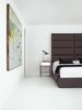 Modern home with Bedroom, Bed, Night Stands, and Painted Wood Floor. Intended for a much bigger room in the family’s previous home, the bed was designed by Hill and is covered in Maharam fabric in a doily print called Intricate 001 Charcoal. The side tables
are from West Elm, and the AJ table lamp is by Arne Jacobsen for Louis Poulsen. Photo of Our Favorite Bedrooms