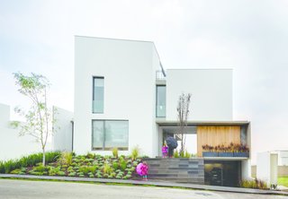 The front door of this house in the Santa Fe neighborhood of Mexico City slides open to allow views all the way to the backyard. 