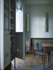 The bespoke sideboard (hiding the stairway to the basement) and the kitchen table were both built from wood sourced from a school science laboratory, while the sliding door that fronts the sideboard was salvaged from the National Museum of Scotland. Photo of Strange Salvaged Materials and Objects in Modern Homes modern home