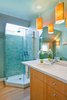 The upstairs bathroom was fitted with a skylight over the shower, adding light and spaciousness to the small room. Locally made Heath tiles line the new shower, and a marble slab salvaged from wainscot at Brooks Brothers in San Francisco now serves as the vanity top. Bamboo light fixtures add warmth. Photo of Strange Salvaged Materials and Objects in Modern Homes modern home