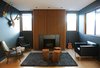 Modern home with Living Room, Wood Burning Fireplace, Standard Layout Fireplace, Chair, Rug Floor, Medium Hardwood Floor, and End Tables. LOS ANGELES HOME WITH WOOD-CLAD INTERIOR
Home owner Bill Thompson warmed up his otherwise dark living room with a series of Douglas fir slats was applied above the fireplace as well as other wood accents throughout the room.
A series of Douglas fir slats was applied above the fireplace. Photo of Fall Design Trend: Warm Woods