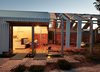 A steel-framed, bi-fold door system by Skyrange Engineering separates the edge of the house from the outdoor area. Photo 2 of Cut Cut Paw Paw modern home