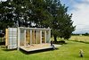 A small shipping container home in New Plymouth, New Zealand features a retractable porch. Photo credit: Paul McCredie Photo of Amazing Examples of Shipping Container Architecture modern home