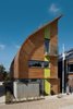 Modern home with Exterior, Wood Siding Material, House, and Curved RoofLine. The most unique feature of the Lighthouse is the windcatcher, or the vertical void that cuts down through the center of the house from the roof. Photo of 16 Funky Facades