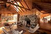 A view through the house shows not only how the roofline folds down across the interior, letting in air and sunlight, but also how beautiful reclaimed wood can be. Photo of Fall Design Trend: Warm Woods modern home