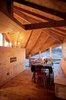 Angled openings in the roofline function as both windows and vents, allowing views and cross-breezes. A dining table completes the nearly all-wood room. Photo of Fall Design Trend: Warm Woods modern home