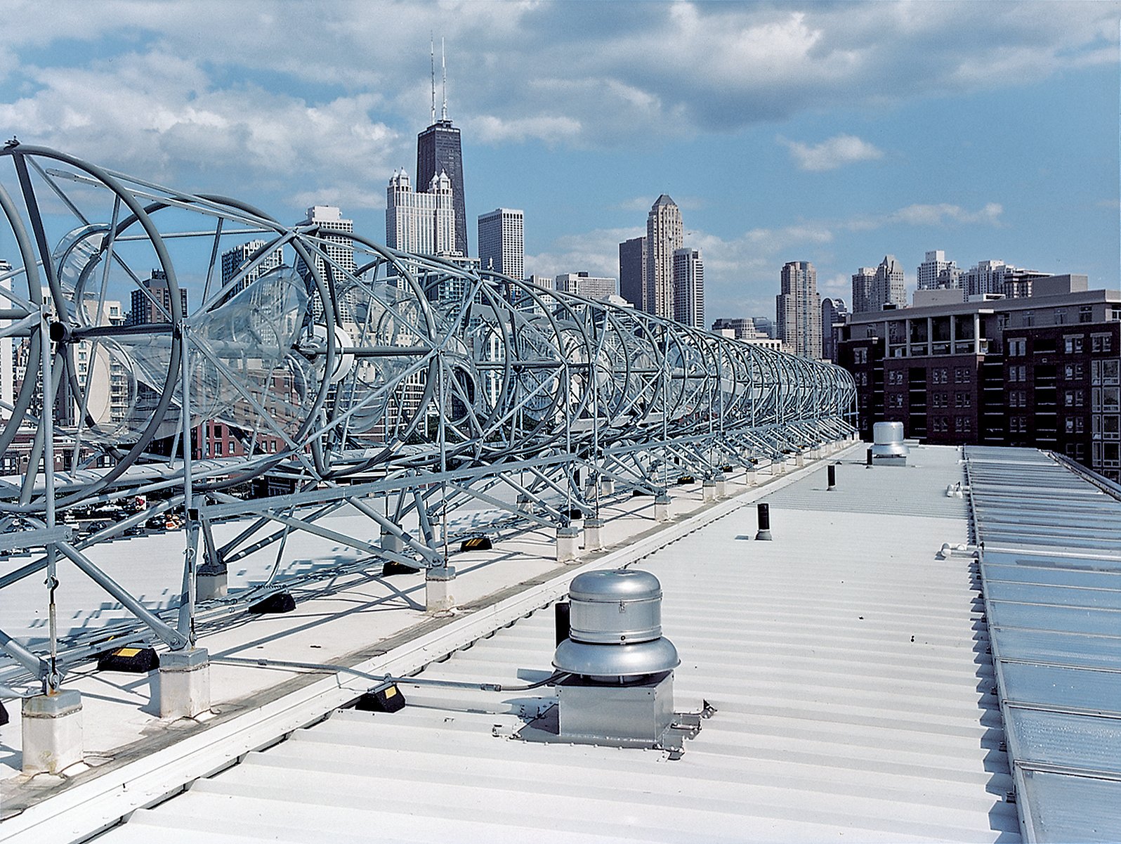 A horizon-line of rooftop wind turbines turns the skies of the Windy City into an omnipresent source of electrical power. Installed by the Chicago-based firm Aerotecture International, the turbines give the building both a steady supply of power and a distinct appearance, visible from several blocks away.