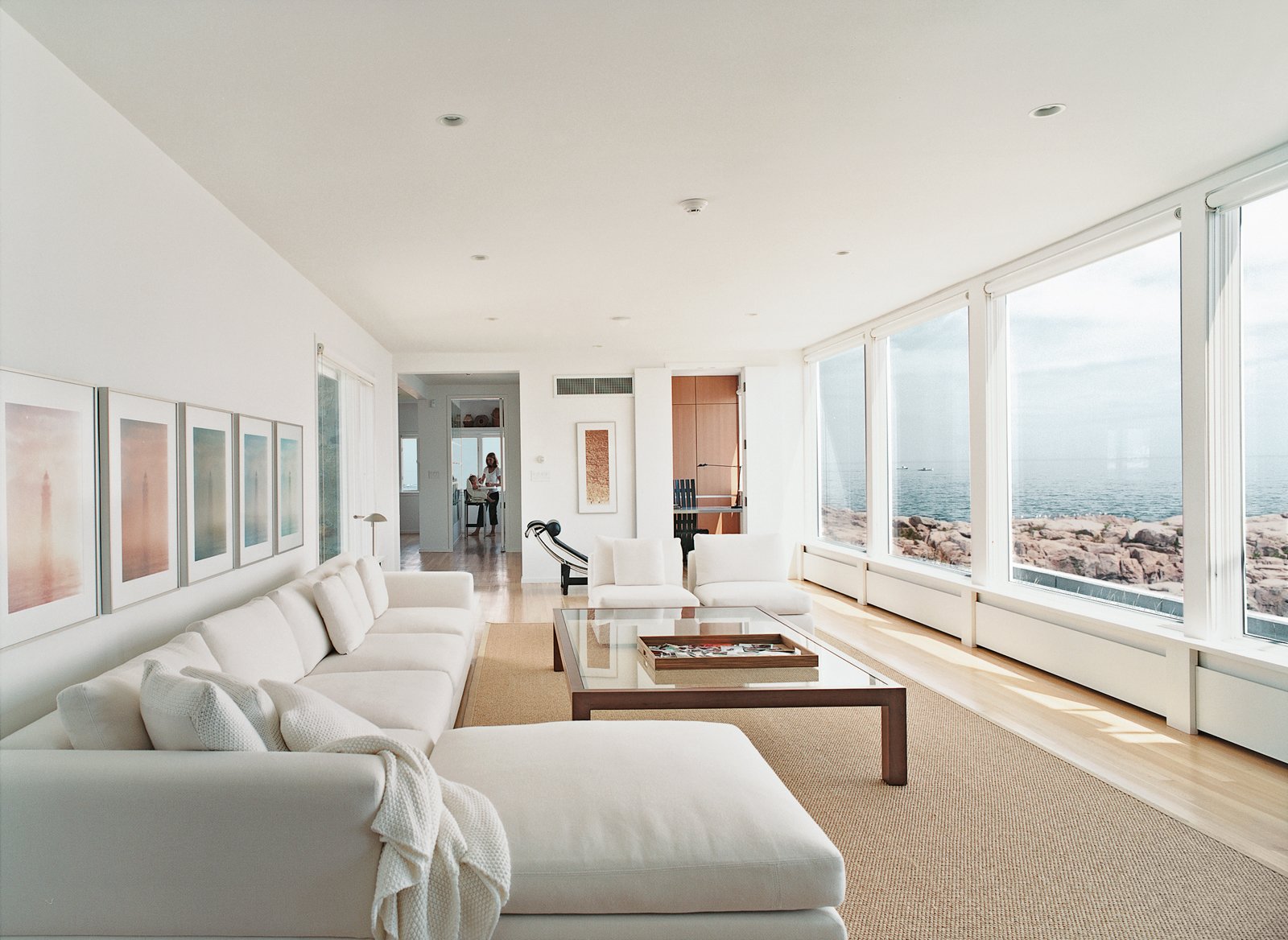 In the living room, there's a black leather Le Corbusier lounge and a Minotti sofa set.