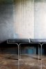 Modern home with Living Room and Bench. An aluminum bench harmonizes with the industrial nature of the galvanized-steel walls and the polished concrete floor. Photo of Steel Yourself