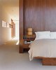 Modern home with Bedroom, Bed, Storage, Table Lighting, and Carpet Floor. The master bedroom interior is finished with cherry wood. Photo of Our Favorite Bedrooms