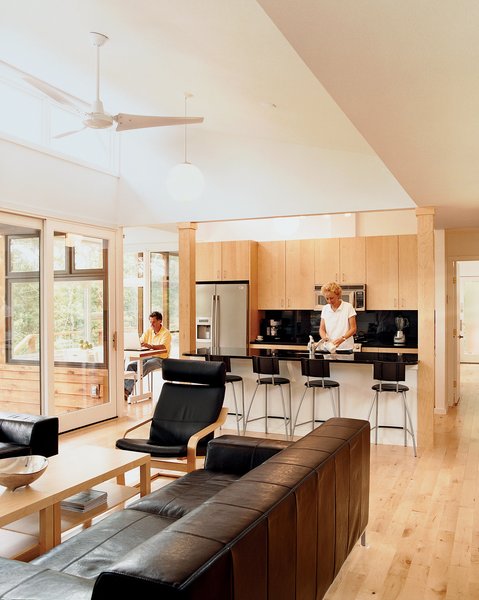 The Kieslings in their open kitchen. The maple used throughout references the maple trees that surround the house.