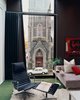 Modern home with Living Room, Chair, Sofa, and Rug Floor. The most dramatic view in the apartment, the First Presbyterian Church looms large in the Kovel living room. Photo of Take Two: 7 Adaptive Reuse Projects We Love