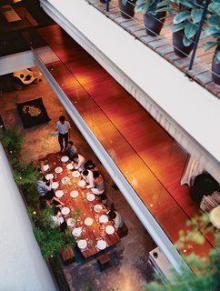 The dining table, made from a single piece of teak, is a little over 13 feet long and was custom made for the space. It can seat up to 24.