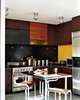 Charles de Lisle, of the interior design firm Your Space, designed the kitchen backsplash of PVC rubber flooring embedded with stainless steel "plus" signs. The restaurant supply table is flanked by steel-and-wood Lem Piston stools from Design Within Reach. Photo of Space-Saving Hacks for Small Kitchens modern home