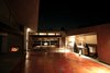 The two sides of the house look across the courtyard at each other, and are bridged by the dining room, which looks out onto the street below like the wheelhouse of a ship. “Everyone ends up in the kitchen anyway, so why not put the kitchen in the courtyard?” says Robertson. The kitchen features a NanaWall system that opens directly to the outdoors. The only two enclosed rooms in the house are the bedrooms. Photo 2 of Courtyard House modern home