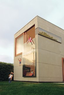 An 8-by-12-foot piece of tempered glass on the front of the house serves as a window for the first-floor den and a railing for the second-floor office.