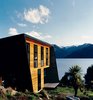 Modern home with Exterior, House, Wood Siding Material, and Metal Siding Material. The sunny side of the home is clad in cedar weatherboards and features sleeping quarters on the upper level with living spaces below. Photo of Stunning Waterfront Structures