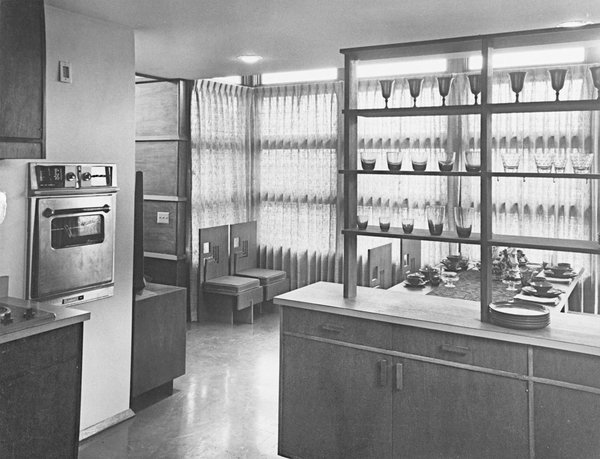 Interior of prefab house showing kitchen looking out into dining room, designed by Frank Lloyd Wright.