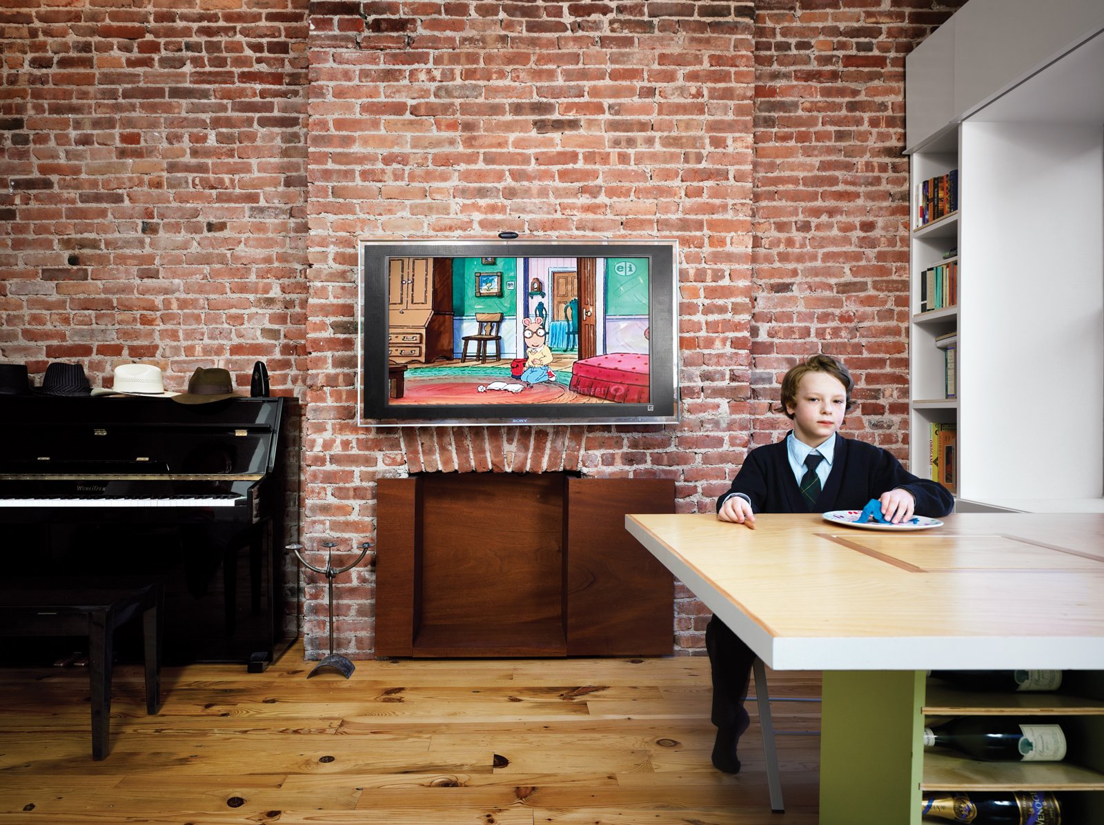 The exposed original brick is one of the few reminders of the apartment’s old bones.