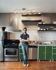 Modern home with Kitchen, Ceiling Lighting, Colorful Cabinet, Medium Hardwood Floor, Metal Cabinet, Metal Counter, Range Hood, and Range. Mazza and Patten both used off-the-shelf Ikea cabinets in their kitchens. They customized them by raising them up a few inches and dropping a sink into a store-bought table, which serves as the countertop. The pair is thrilled with the results. Even the architects they hired to work at the deli from Grupo 7 were impressed: “They said, ‘These cabinets are insane. How do we get them?’” Mazza recalls. Photo of Winning Bids: 7 Unbelievable Online Finds