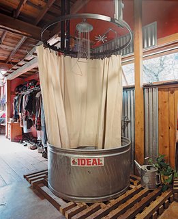 The showers are made from stock-watering tanks from the Ideal Stock Tank Co. and have waterproof canvas curtains. Less expensive than prefab shower-tub units, stock tanks are built of weatherproof galvanized steel and are sturdy enough for cows to drink from—–and, ergo, for you to bathe in.