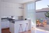 Grist and Goldberg wanted an open kitchen so their guests could gather around a beautiful space without feeling cramped in a tiny room. Goldberg instantly fell in love with an Ann Sacks glass tile backsplash that Samaha and Hart showed the couple during the design process, but she wasn't willing to spend $100 per square foot on the product. Instead, Goldberg had their contractor make three panels of cement board that would fit in the backsplash space and she and a friend spent their evenings gluing on glass tiles that she purchased online. When they finished, the contractor came back, installed the panels, and Goldberg filled in the gaps. Outside, chairs from Ikea and an Inox table from DWR provide a space to sit on the deck.
Photo by
Sharon Risedorph Photo of How to Design with Orange modern home