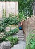 Modern home with Outdoor, Back Yard, Wood Fences, Wall, and Horizontal Fences, Wall. In the back, ivy climbs across the garage’s raw cedar cladding next to a gate that allows access to the laneway—but the boys prefer to climb the fence. Photo of 30+ Best Modern Fences
