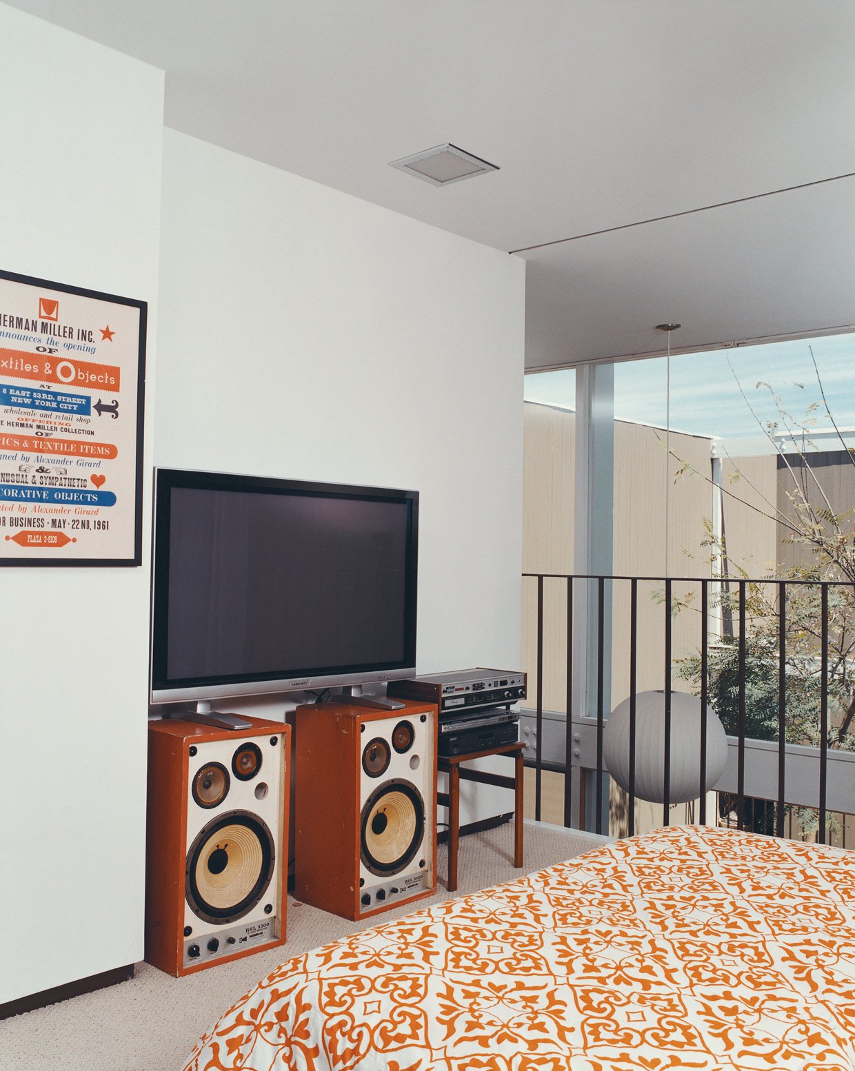 An Alexander Girard poster for the Herman Miller Textile & Objects Shop in the master bedroom is original to the house.
