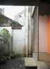 An orange door and metal grille make for a warm, if industrial, contrast to the stones and plants on the patio. They also weather well, something critical in a place where the climate leads to a palpable sense of decay. Photo of How to Design with Orange modern home