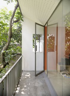 That orange accent is carried from a door downstairs to the family room upstairs and a glazed facade keeps things very bright indeed.