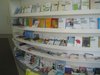 Past the computer nook is this curved wall of pamphlets, books, and literature about cancer, coping, and surviving. Photo of Maggie's Center by Zaha Hadid modern home