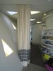 One of Hadid's design goals was to make the space as flexible as possible, so though there are two private rooms where people can meet behind closed doors, the main social spaces are defined by a pair of curtains which themselves can offer some privacy without totally shutting out the rest of the building. Photo of Maggie's Center by Zaha Hadid modern home